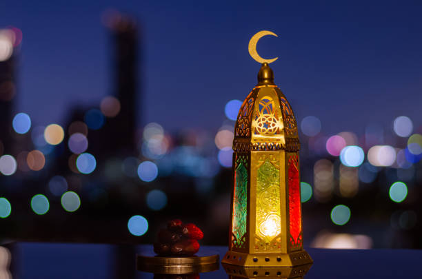 istock Lantern that have moon symbol on top and small plate of dates fruit 1405028442