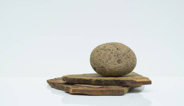 istock light brown oval shaped stone on white background for stand podium background 1405032129