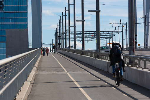 Gothenburg, Sweden - April 03 2022: People walking and biking across Hisingsbron.