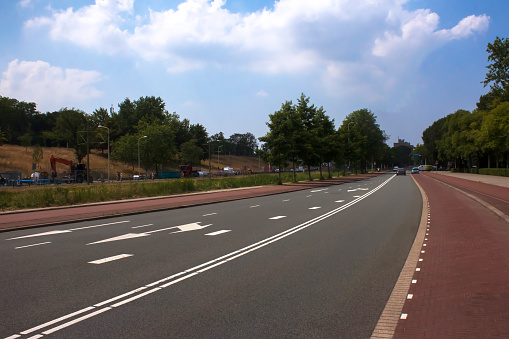 Urban road and bike lanes under blue skies in The Hague , the Netherlands