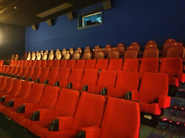 istock Empty cinema hall seat with nachos and cola 1405036047