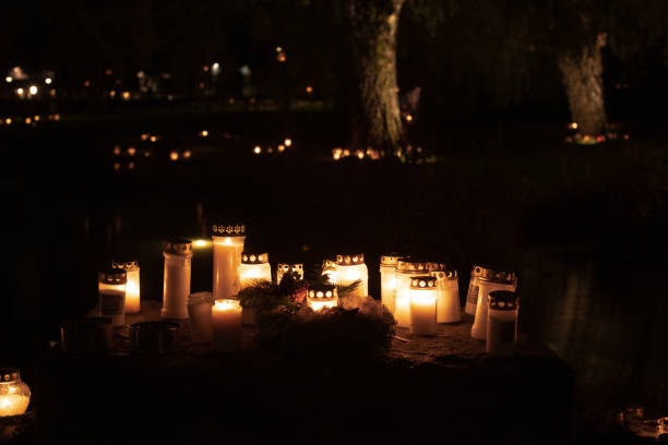 Gothenburg, Sweden - november 07 2021: Grave candles lit at a cemetery at all hallows eve.