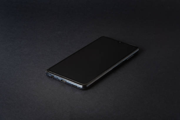istock black, clean phone on a black background, close-up 1405037527