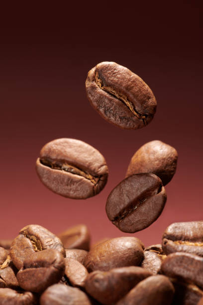 istock Roasted coffee beans closeup on brown gradient background 1405039482