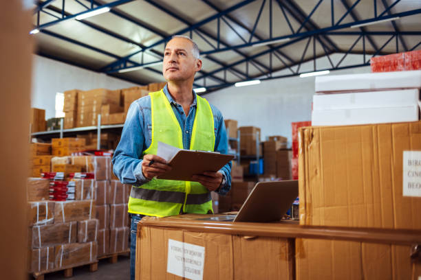 istock Male logistic manager checking on clipboard checklist 1405039858