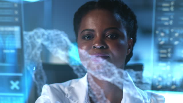 An African -American scientist in close-up behind the HUD screen with a medical model on it