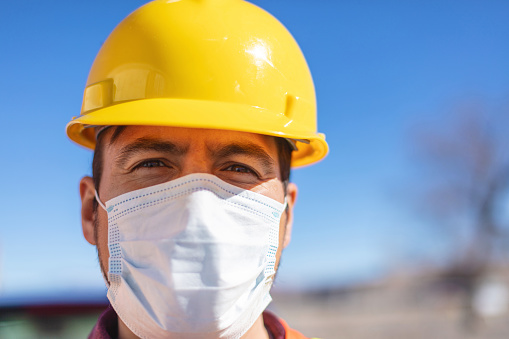 Western USA Male Contractor Hispanic Male Construction Worker on Work Site Wearing PPE and Mask Evaluating Projects Infrastructure Photo Series