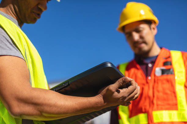 istock Black and Hispanic Male Construction Workers on Work Site Wearing PPE Evaluating and Discussing Projects Infrastructure Photo Series 1405043553