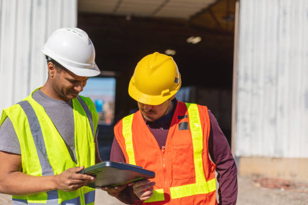 istock Black and Hispanic Male Construction Workers on Work Site Wearing PPE Evaluating and Discussing Projects Infrastructure Photo Series 1405043898