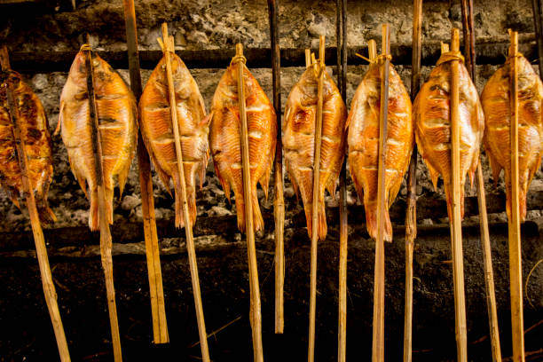 istock grilled fish, grilled fish nile Tilapia grilled on hot charcoal 1405047732