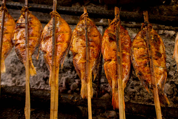 istock grilled fish, grilled fish nile Tilapia grilled on hot charcoal 1405047831