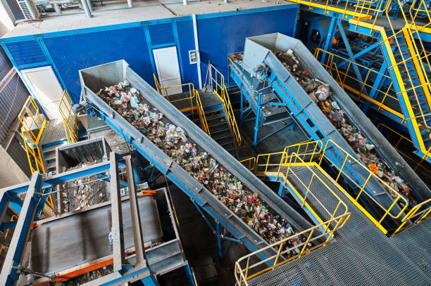 istock Large production line with conveyors carrying trash at plant 1405051813