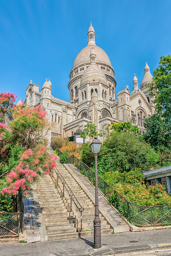 Sacre-Coeur de Montmartre in early morning light. Soft color effects with added grain.