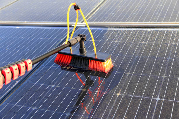 Gentle cleaning of solar modules with water Cleaning of solar modules with water and a soft brush. broom photos stock pictures, royalty-free photos & images