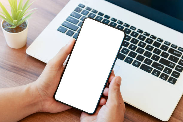 istock mockup copy space phone, man's hand holding smartphone with blank white copy screen for your advertising 1405055363