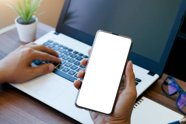 istock mockup copy space phone, man's hand holding smartphone with blank white copy screen for your advertising. 1405057136