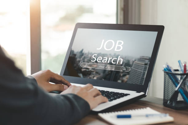 istock Young men back view online job search using computer app job search. 1405057990