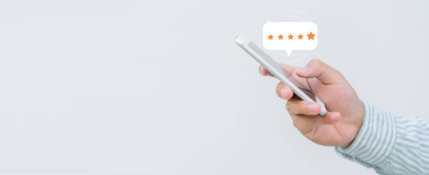 istock close up on customer man hand pressing on smartphone screen with  five star rating feedback icon and press level excellent rank for giving best score point to review the service , technology business concept 1405061298