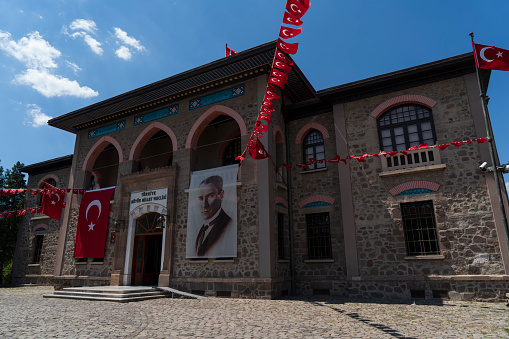 Ankara, Turkey - May 18, 2022: Turkish flag and Atatürk poster are hanged on the walls of Republic Museum (2.TBMM - Cumhuriyet Müzesi) in Ankara, Turkey.