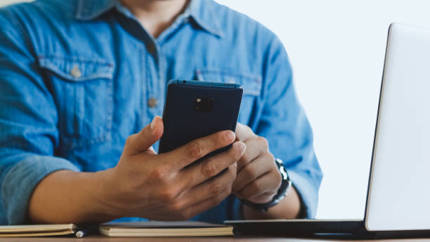 istock Close-up male hands with smartphone. 1405063388