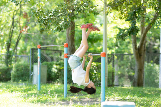 istock Girl playing with iron bars in the park 1405064867