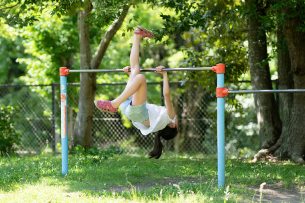 istock Girl playing with iron bars in the park 1405064876