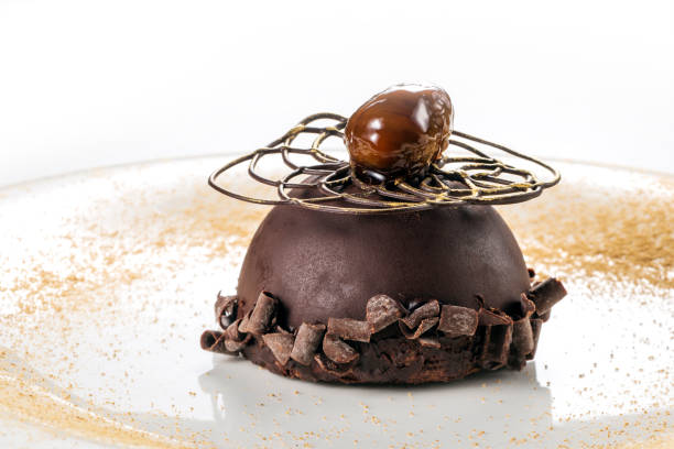 istock Round white plate with chocolate hemisphere with soft chestnut heart 1405066664