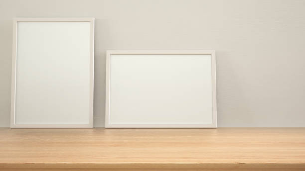 istock Frame mock up on wooden table, desk or shelf. White plaster wall background with copy space, interior design template 1405066828