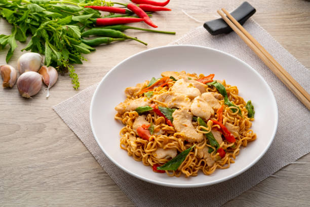 istock Spicy stir fried instant noodle with sliced chicken breast 1405069672