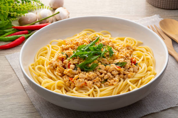 istock Spaghetti topped with stir fried minced chicken and basil 1405070593