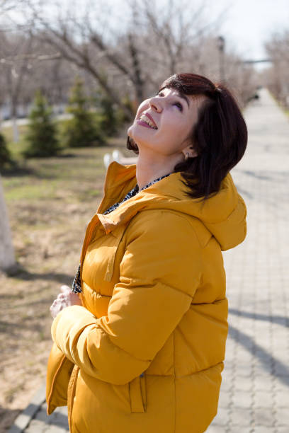 istock Woman in jacket enjoying spring weather, walking after work 1405071684