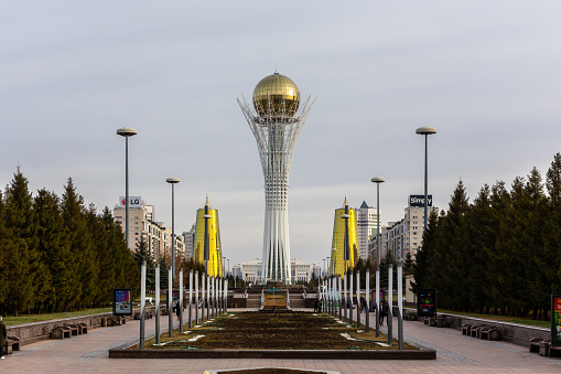 Nur Sultan (Astana), Kazakhstan, 11.11.21. Baiterek (Bayterek) Tower, landmark of Nur Sultan, symmetrical view along Nurjol Boulevard with two Golden Towers on the sides.