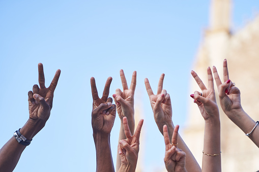 Group of multiracial people making peace or victory sign with hands. Diversity concept.