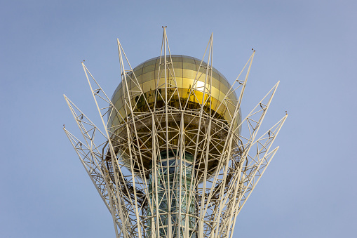 Nur Sultan (Astana), Kazakhstan, 11.11.21. Baiterek (Bayterek) Tower top, national landmark of Nur Sultan with golden sphere symbolizing golden egg against blue sky.