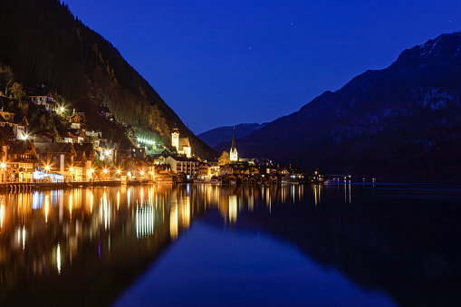 Hallstatt in the Salzkammergut Upper Austria is a world-famous tourist destination and is located on Lake Hallstatt. Night shot with illuminated Catholic and Protestant churches.