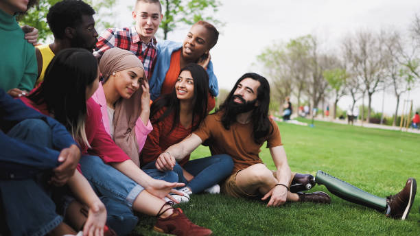 Group of young multiracial friends having fun together in park - Friendship and diversity concept stock photo