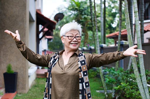 Cheerful adult woman gesturing in front of the camera