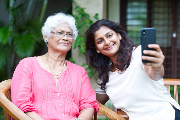 istock Mother and Daughter taking Selfie 1405075444