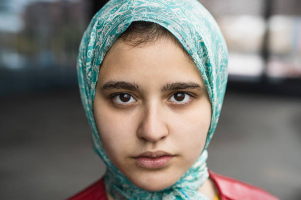 Closeup portrait of muslim girl looking in camera stock photo