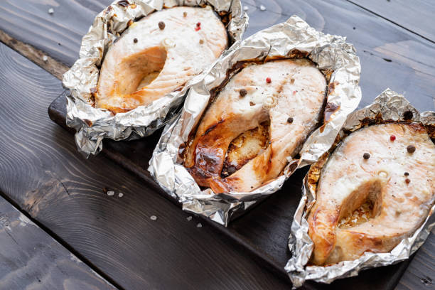istock Grilled salmon steak on dark wooden background 1405082054