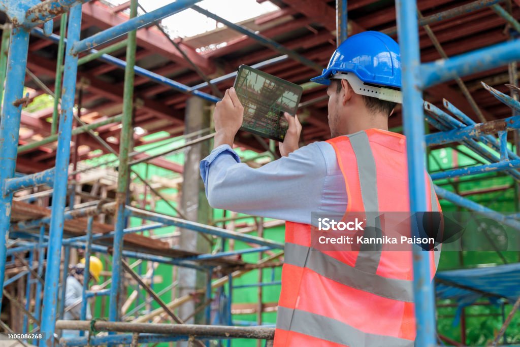 Young Asian Construction Worker Using Tablet While Working At ...