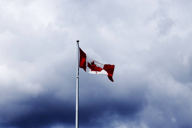 istock Canadian flag on a flagpole with a dramatic clouds 1405086492