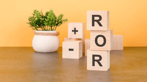 istock ROR the word on wooden cubes, cubes stand on a reflective surface, in the background is a business diagram. Business and finance concept 1405092588
