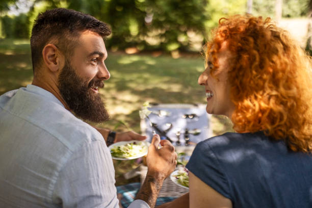 istock Romantic couple enjoying picnic together 1405093437