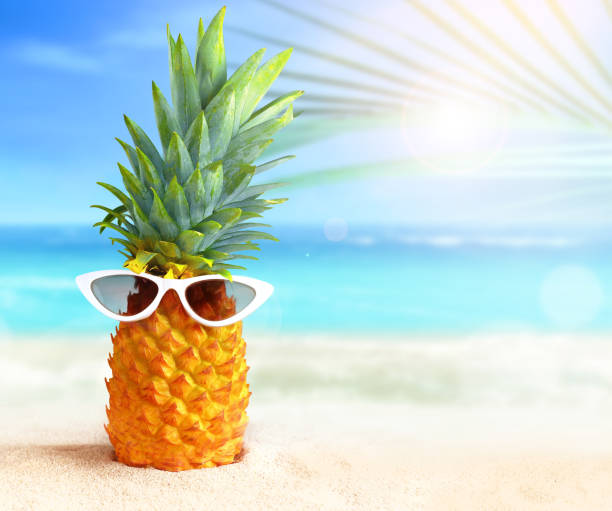 istock Pineapple with sunglasses on tropical beach background. Summer beach concept. 1405096066