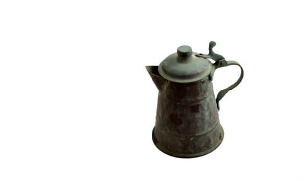 oxidized old copper jug, isolated on white background. stock photo