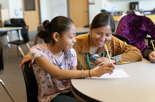 Indigenous Navajo Teacher helping a student in a one to one