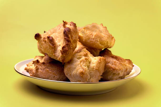 istock unfilled profiteroles in plate on yellow background 1405106216