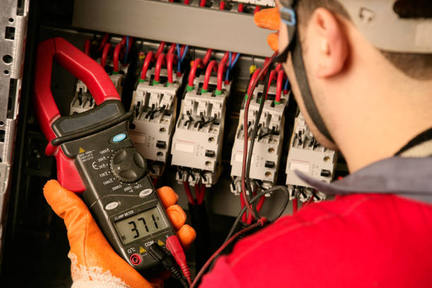 Electrician working on electric panel stock photo