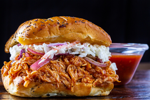 BBQ Pulled Pork Sandwich with everything roll and sauce cup